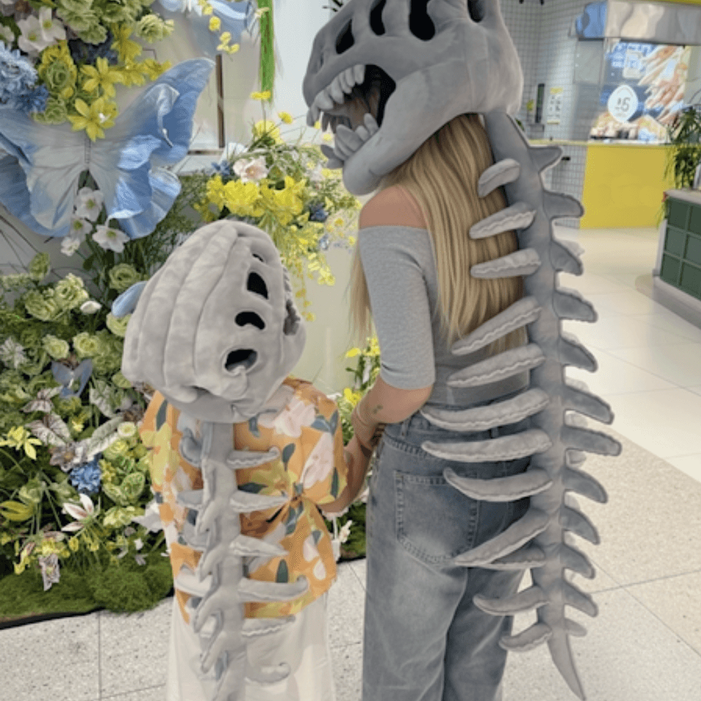 ROARSOME dino skeleton plush headgear worn by a child